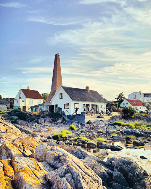 Eiscafé Is Kalas Bornholm mit Terrasse an der felsigen Küste von Sandvig