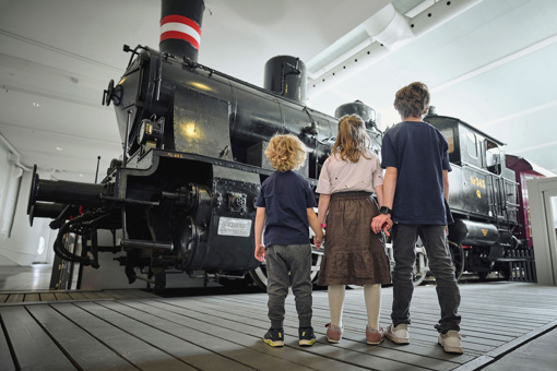 Kinder bestaunen ein Lokomotive im Dänischen Eisenbahnmuseums in Odense